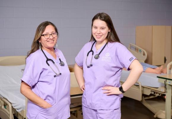 two Nursing students standing in a lab