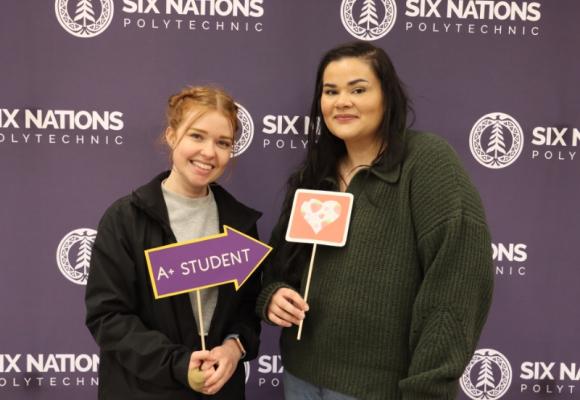 two women holding school signs