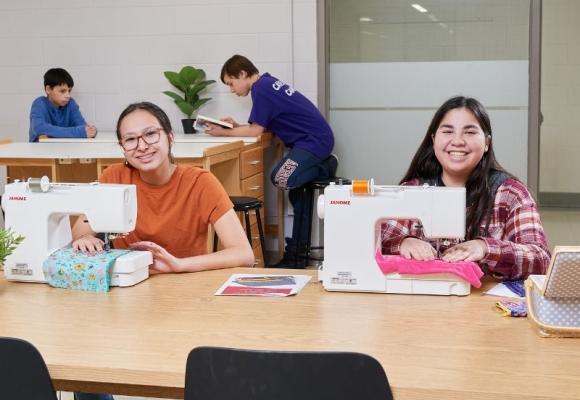 high school students at sewing machines