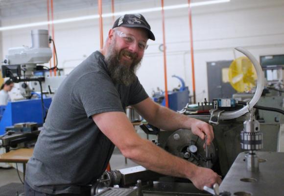 man using a milling machine