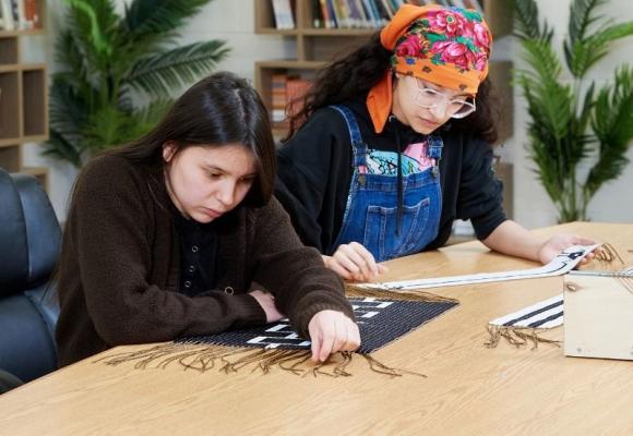 students studying wampum belts