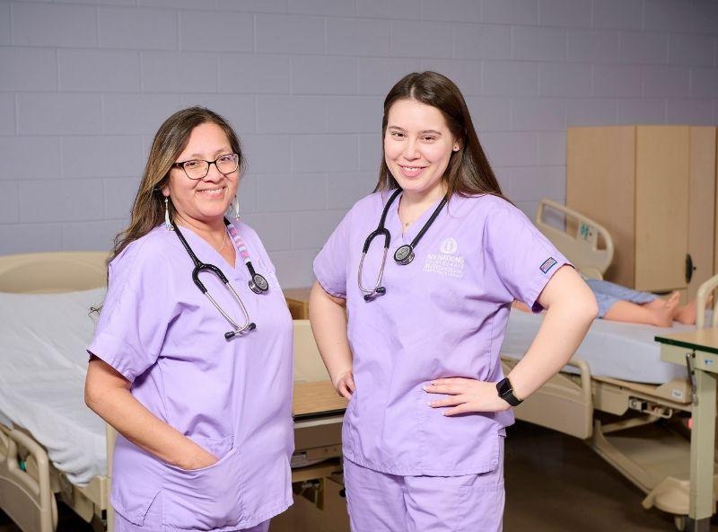 two Nursing students standing in a lab
